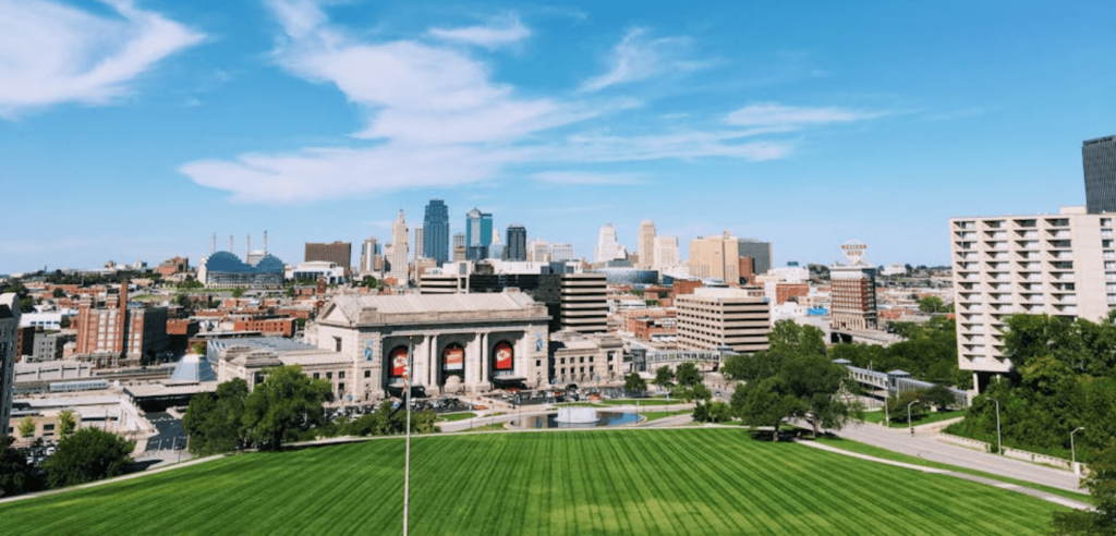 A cinematic sunset view of the skyline and fountains, highlighting the best places to visit in kansas city during a professional kansas city tour.