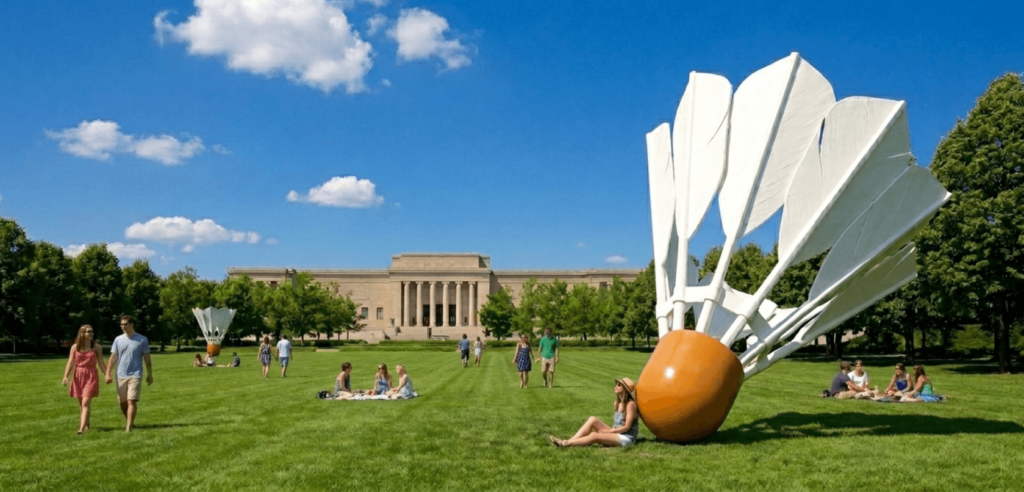 The iconic giant shuttlecock sculptures on the green lawn of the Nelson-Atkins Museum, blue sky, modern architecture in background, professional travel photography.