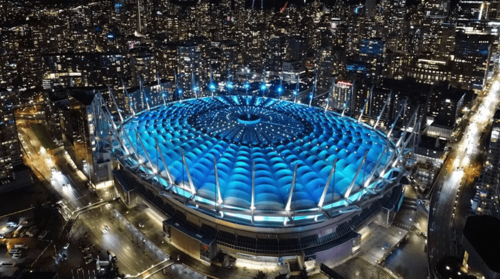 BC Place stadium exterior at night with iconic white inflatable roof glowing against the Vancouver skyline